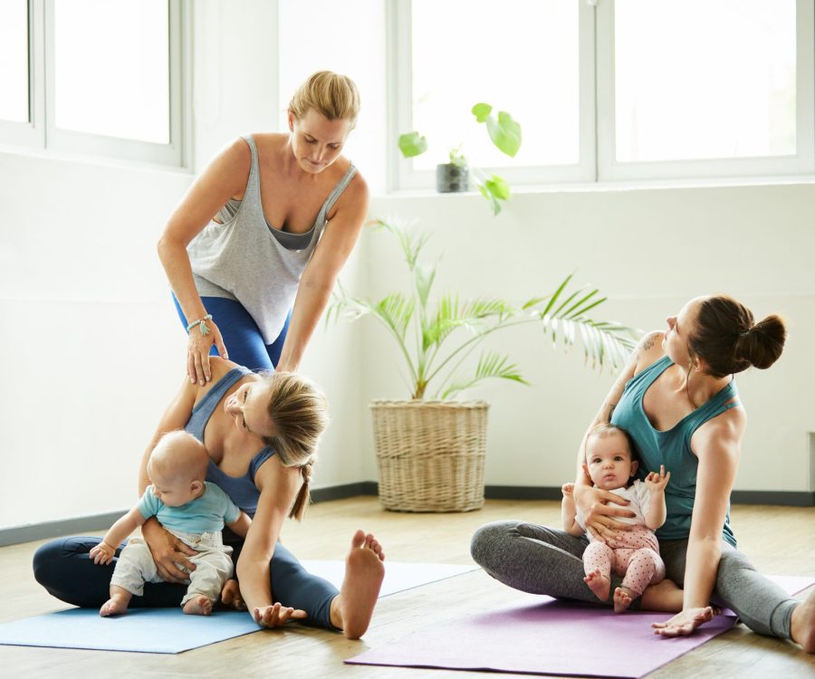 Full length shot of two attractive young mothers sitting with their babies during a baby yoga class indoors